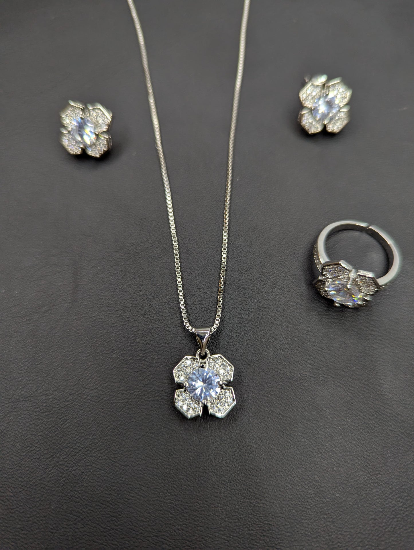Elegant Silver-Tone Flower Jewelry Set with Sparkling Crystals (Necklace, Earrings & Ring)  Product Description: